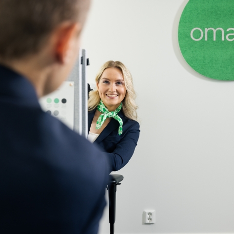 Asiantuntija katsoo pöydän takaa.